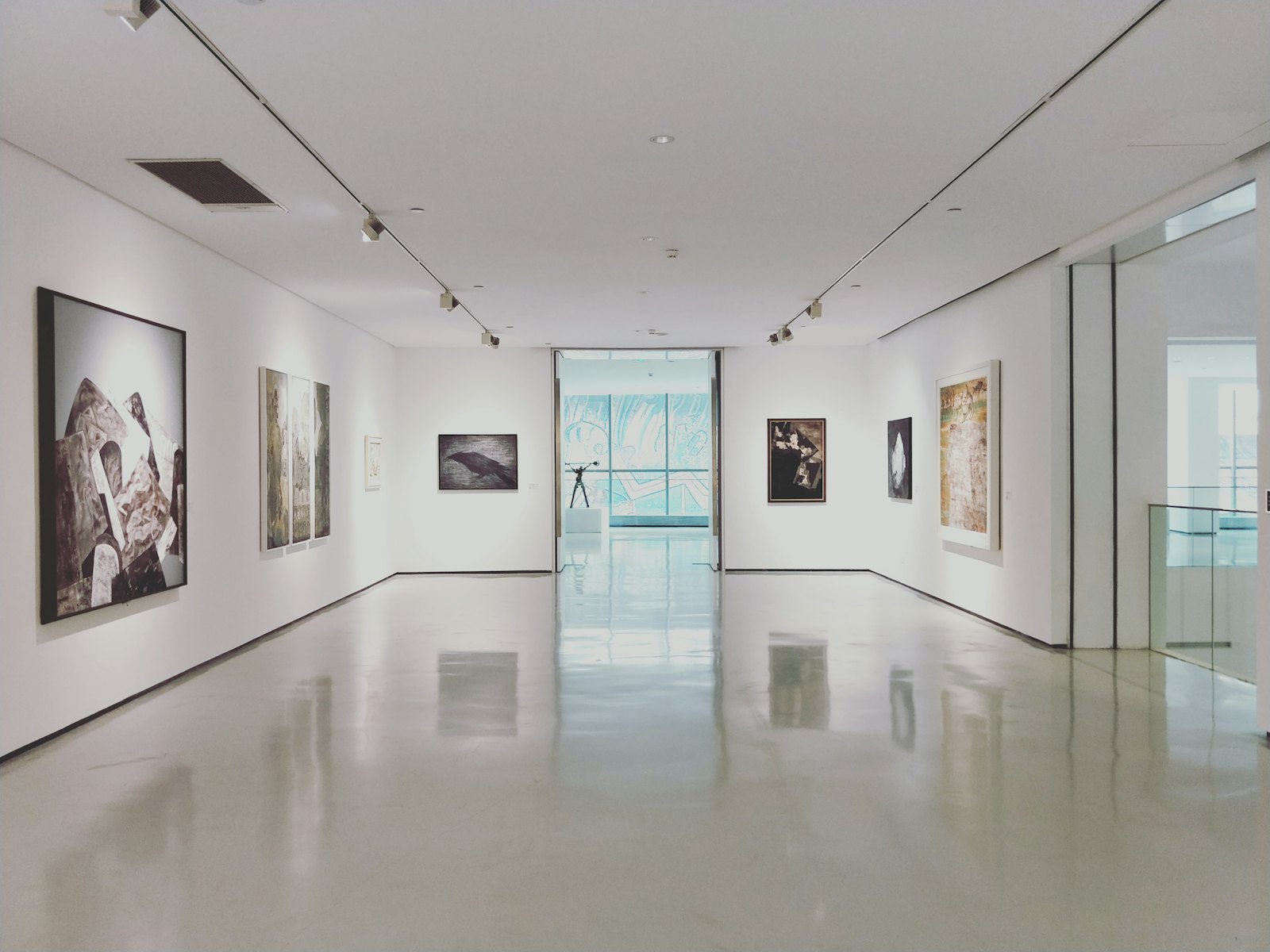 Bright white art gallery space with framed works on the walls, set up for an open studio and Christmas fair