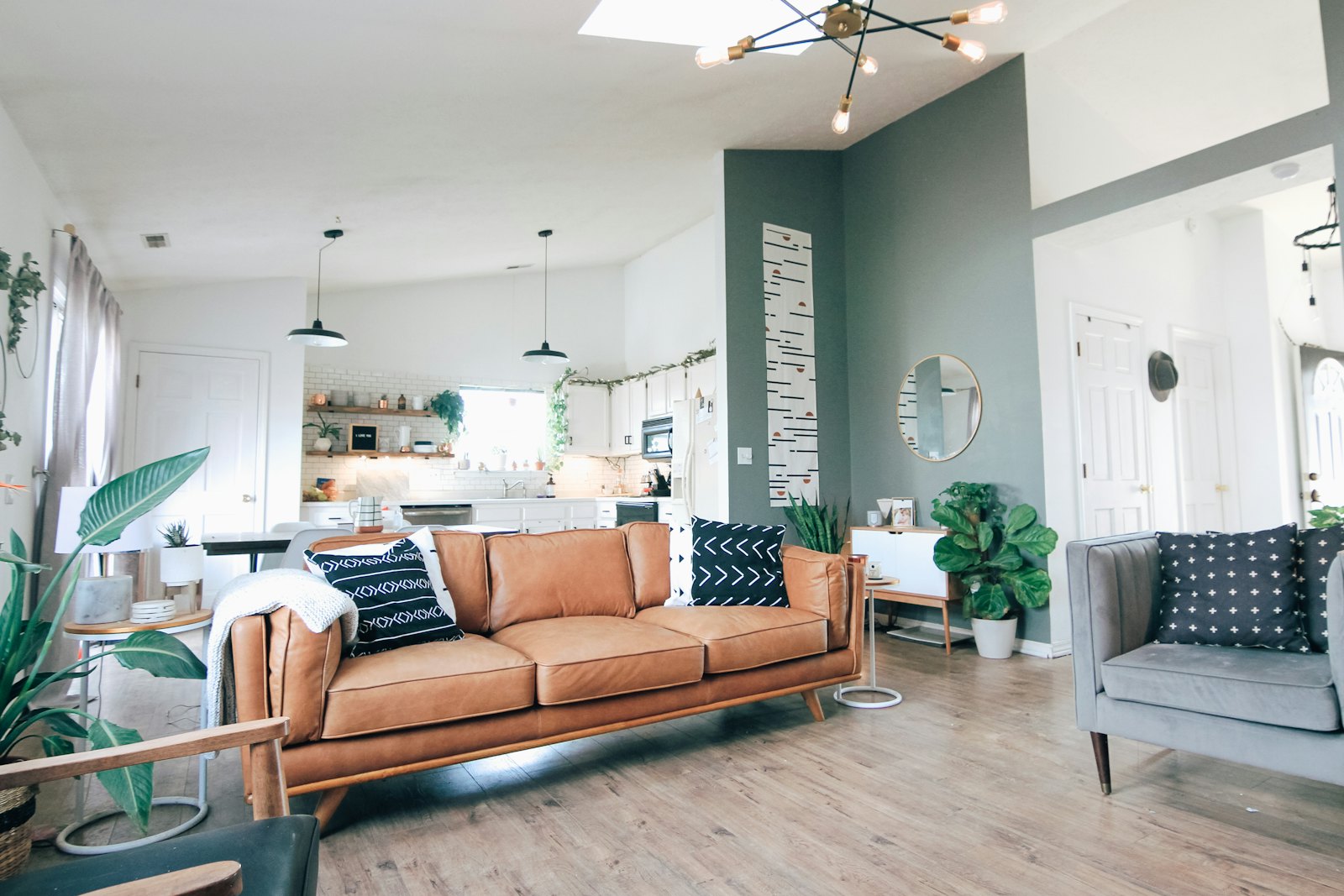 Bright living room with a grey sofa, round coffee table and soft rug, styled in the relaxed West Elm London look